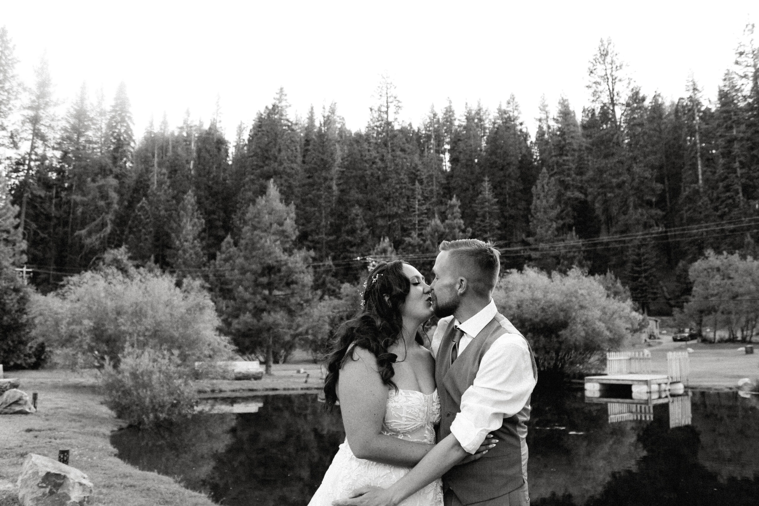 A candid documentary-style photo of a couple embracing in the rugged beauty of Lassen National Park, surrounded by volcanic peaks, lush greenery, and serene natural light. Capturing their authentic connection, this image highlights the artistry and emotion of storytelling photography. Perfect inspiration for couples seeking a Tucson, Arizona wedding photographer for their adventure or destination wedding.