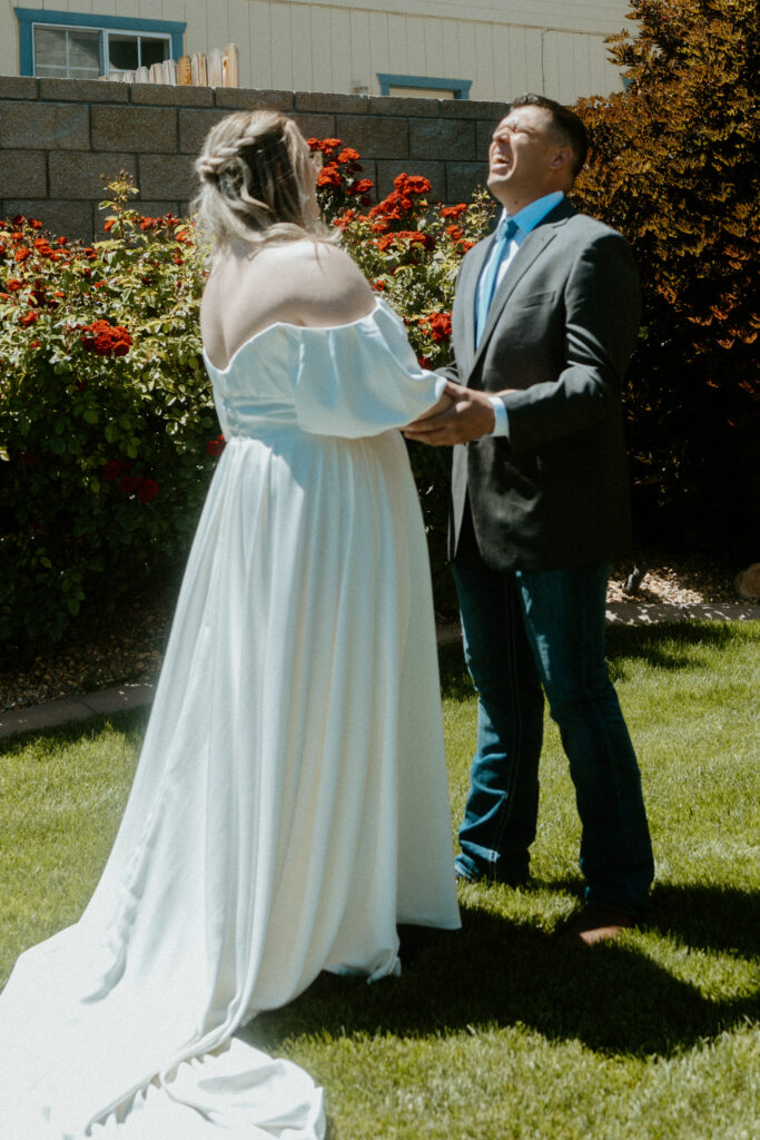 A heartfelt first look moment captured by a Tucson wedding photographer: The couple sees each other for the first time on their wedding day, sharing emotional smiles and tears in a stunning Arizona desert setting."