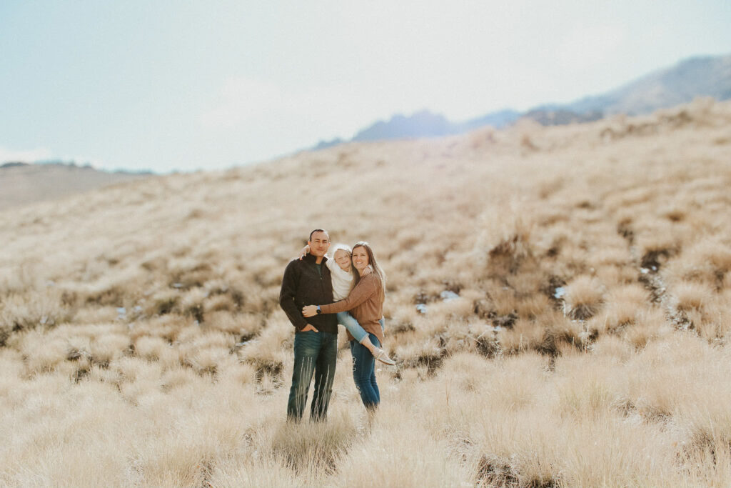 A heartwarming family photo captured by a Tucson wedding photographer: The couple poses with their children in the beautiful Arizona desert, surrounded by cacti and warm golden light, creating a timeless memory.